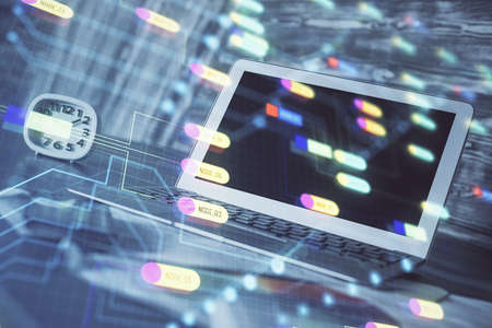Double exposure of laptop computer and technology theme hologram. Concept of freelance work.