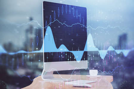 Financial chart drawing and table with computer on background. Double exposure. Concept of...
