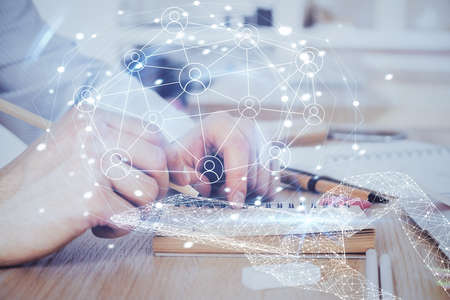 Man's hands working with notes background. Social networking scheme . Mixed media. Global business. Multi exposure.の写真素材