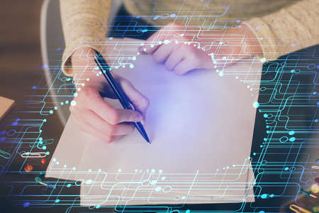 Double exposure of writing hand on background with data solution technology hologram. Ai concept.の写真素材