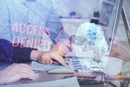 Fingerprint hologram with businessman working on computer on background. Security concept. Double exposure.の写真素材