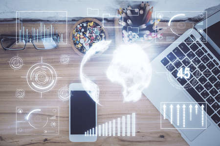 Double exposure of financial graph hologram over desktop with phone. Top view. Mobile trade platform...