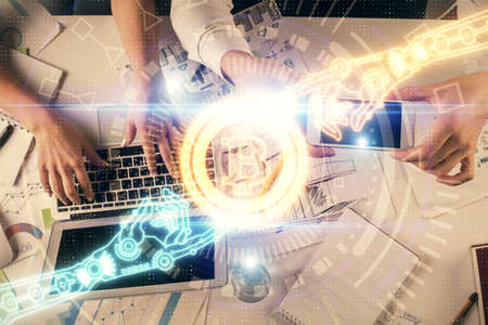 Double exposure of man and woman working together and crypto theme hologram drawing. Computer...