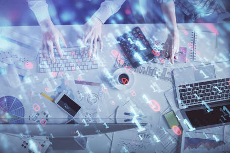 Double exposure of man and woman working together and data theme hologram drawing. Computer background. Top View.の写真素材