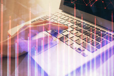 Double exposure of woman hands typing on computer and forex chart hologram drawing. Stock market...