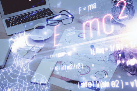 Desktop computer background and formula hologram writing. Double exposure. Education concept.の写真素材