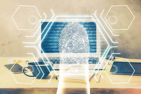 Computer on desktop in office with finger print drawing. Double exposure. Concept of business data...