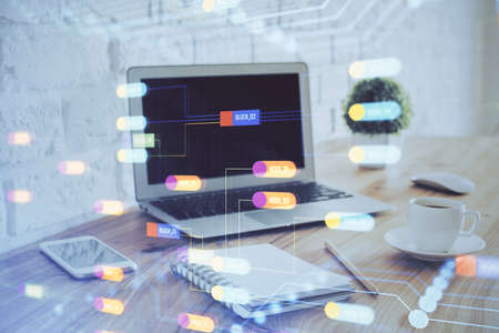 Double exposure of laptop computer and technology theme hologram. Concept of freelance work.