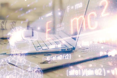Desktop computer background and formula hologram writing. Double exposure. Education concept.
