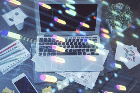 Double exposure of laptop computer and technology theme hologram. Concept of freelance work.の写真素材