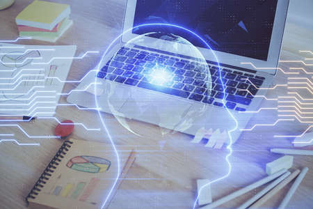Multi exposure of work table with computer and brain hologram. Brainstorm concept.