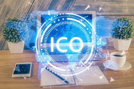 Multi exposure of blockchain theme hologram and table with computer background. Concept of bitcoin crypto currency.の写真素材