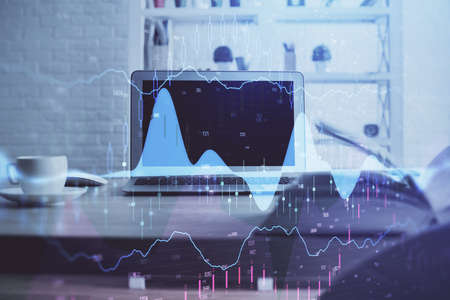 Forex market graph hologram and personal computer on background. Double exposure. Concept of...