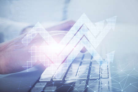 Growing arrows with businessman working on computer on background. Success concept. Double exposure.の写真素材