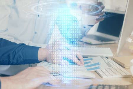 Double exposure of technology hologram with man working on computer background. Concept of big data.の写真素材