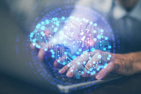 Businessman with computer background with brain theme hologram. Concept of brainstorm. Multi...