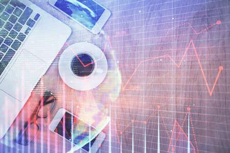 Multi exposure of financial chart hologram over desktop with phone. Top view. Mobile trade platform...