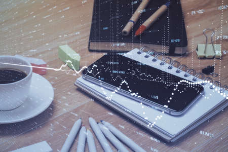 Double exposure of forex chart drawing and cell phone background. Concept of financial tradingの写真素材