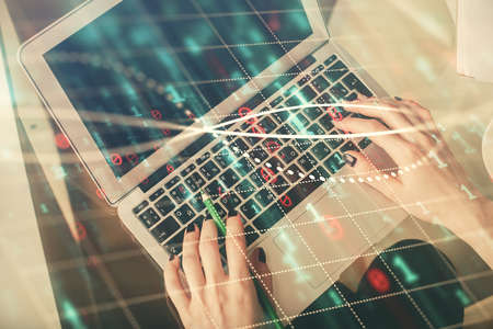 Double exposure of woman hands working on computer and forex chart hologram drawing. Top View....