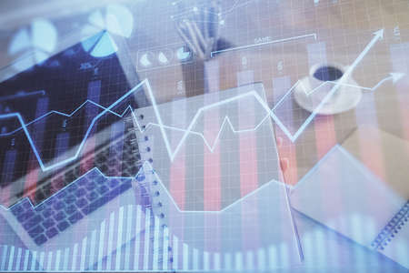Double exposure of businesswoman hands typing on computer and forex chart hologram drawing....