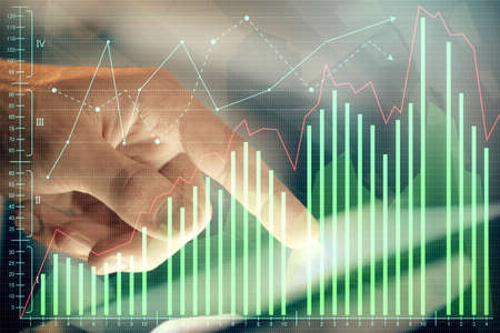 Multi exposure of man's hands holding and using a phone and financial chart drawing. Market analysis...
