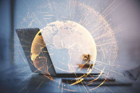 Computer on desktop with social network hologram. Double exposure. Concept of international people connections.の写真素材