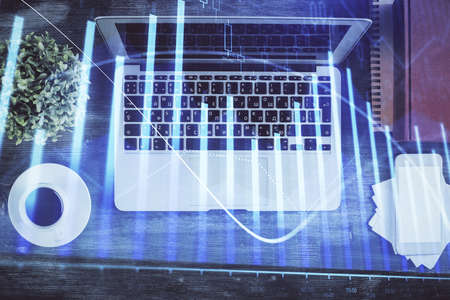 Stock market chart and top view computer on the table background. Double exposure. Concept of...