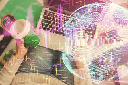 Double exposure of woman hands working on computer and forex chart hologram drawing. Top View....