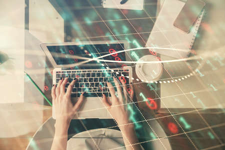 Double exposure of woman hands working on computer and forex chart hologram drawing. Top View....