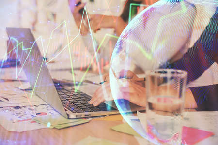 Multi exposure of woman hands typing on computer and forex chart hologram drawing. Stock market analysis concept.の写真素材