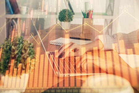 Double exposure of woman hands typing on computer and forex chart hologram drawing. Stock market...
