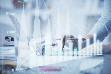 Double exposure of woman hands typing on computer and forex chart hologram drawing. Stock market...