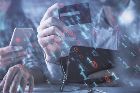 Double exposure of man and woman on-line shopping holding a credit card and data theme hologram...