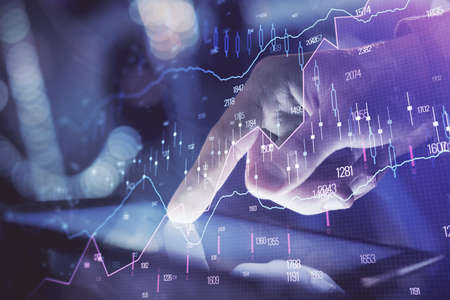 Multi exposure of man's hands holding and using a phone and financial chart drawing. Market analysis...