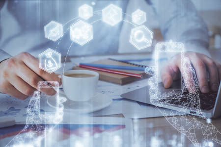 Technology theme hologram with man working on computer on background. High tech concept. Multi exposure.の写真素材