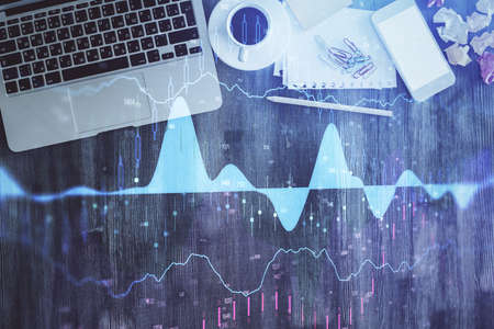 Stock market chart and top view computer on the table background. Multi exposure. Concept of...