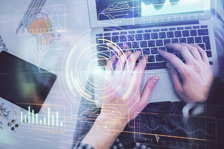 Multi exposure of man's hands typing over computer keyboard and data theme hologram drawing. Top...