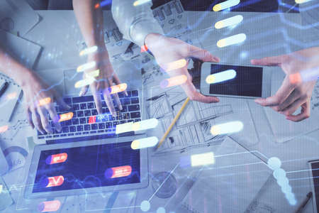 Double exposure of man and woman working together and data theme hologram drawing. Computer...