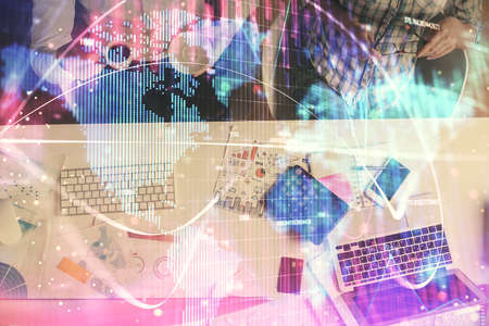 Double exposure of man and woman working together and business theme hologram drawing. Computer...