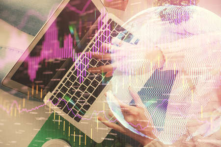 Double exposure of woman hands working on computer and forex chart hologram drawing. Top View....