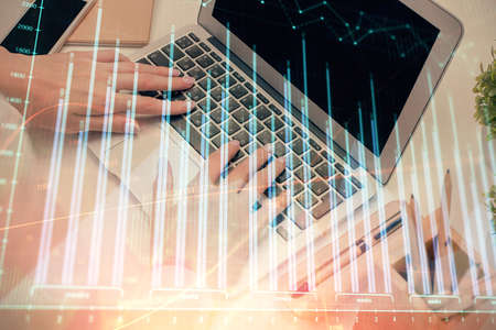Multi exposure of woman hands typing on computer and forex chart hologram drawing. Stock market...