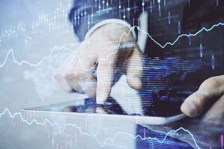 Multi exposure of man's hands holding and using a phone and financial chart drawing. Market analysis...
