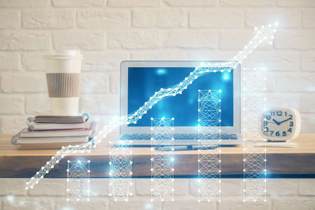 Financial chart drawing and table with computer on background. Multi exposure. Concept of...