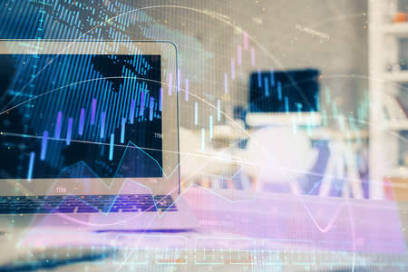 Stock market graph and table with computer background. Double exposure. Concept of financial...
