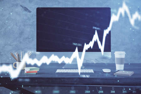 Stock market graph and table with computer background. Multi exposure. Concept of financial...