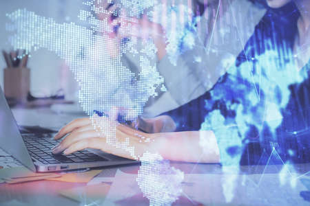 Multi exposure of woman hands typing on computer and financial graph hologram drawing. Stock market analysis concept.の写真素材