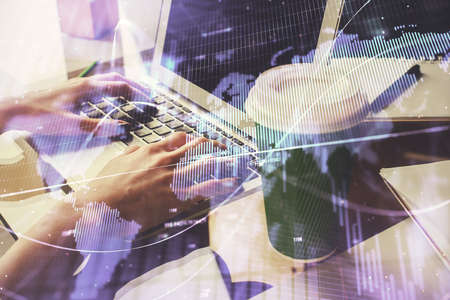 Double exposure of woman hands typing on computer and forex chart hologram drawing. Stock market...