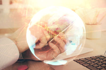 Double exposure of man's hands holding and using a phone and international business theme drawing.