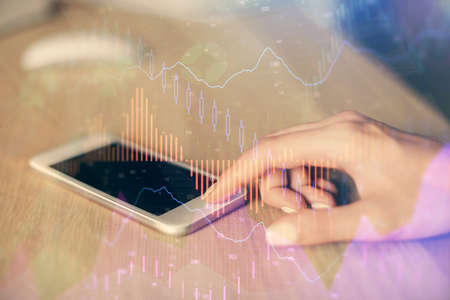 Double exposure of forex chart sketch hologram and woman holding and using a mobile device....