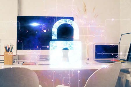 Double exposure of desktop with computer and lock icon hologram. Concept of data safety.